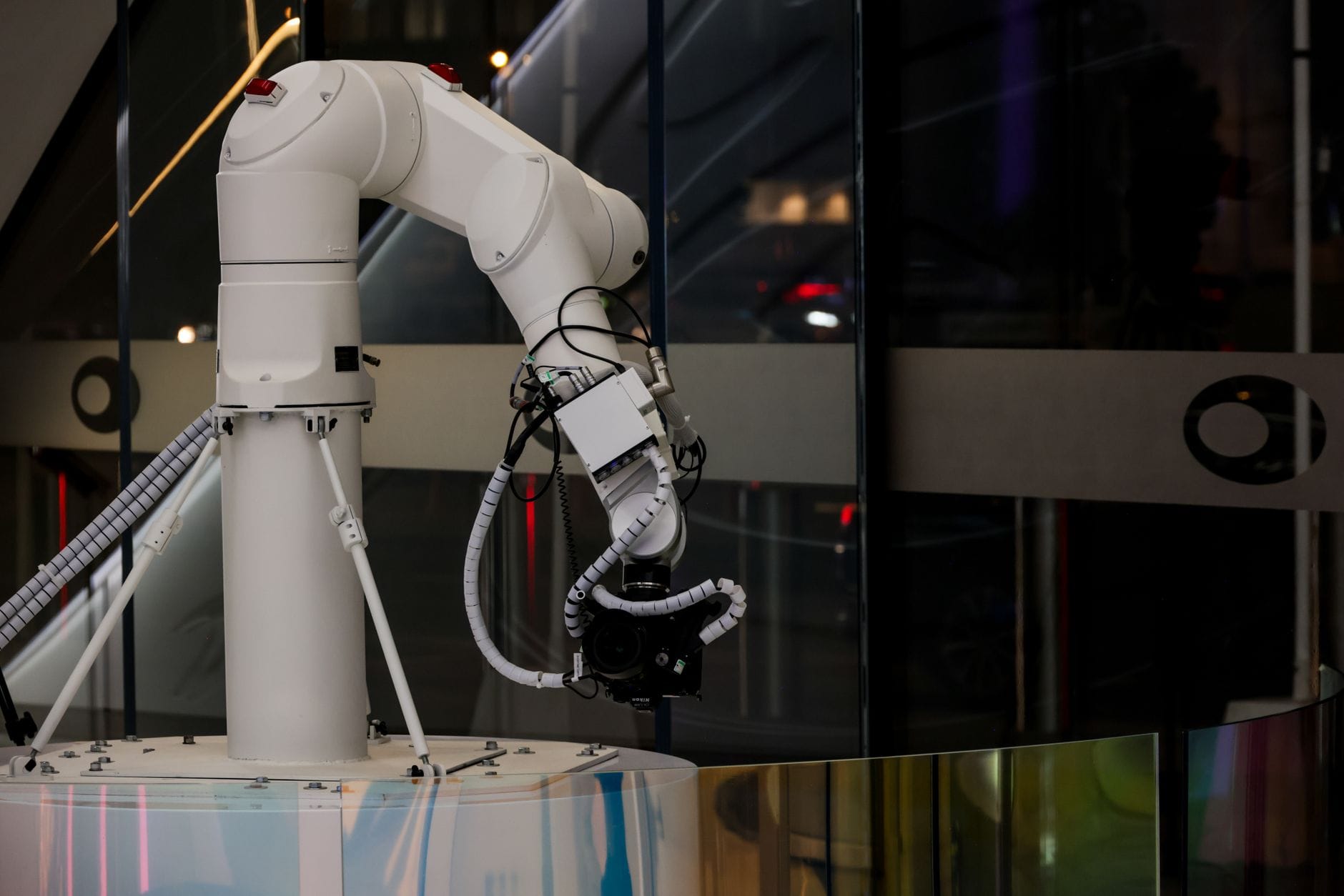 White robotic arm operating on an industrial production floor with advanced automation technology