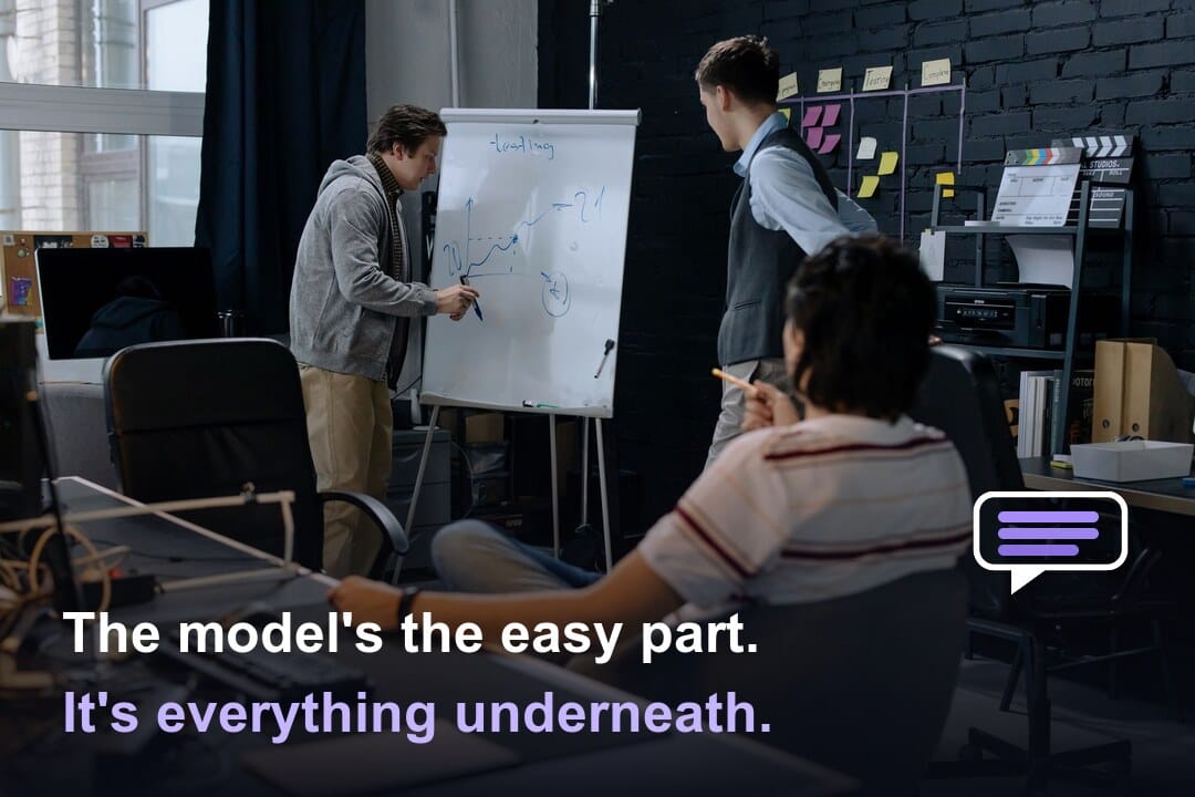 A team at a whiteboard, captioned: The model's the easy part. It's everything underneath.