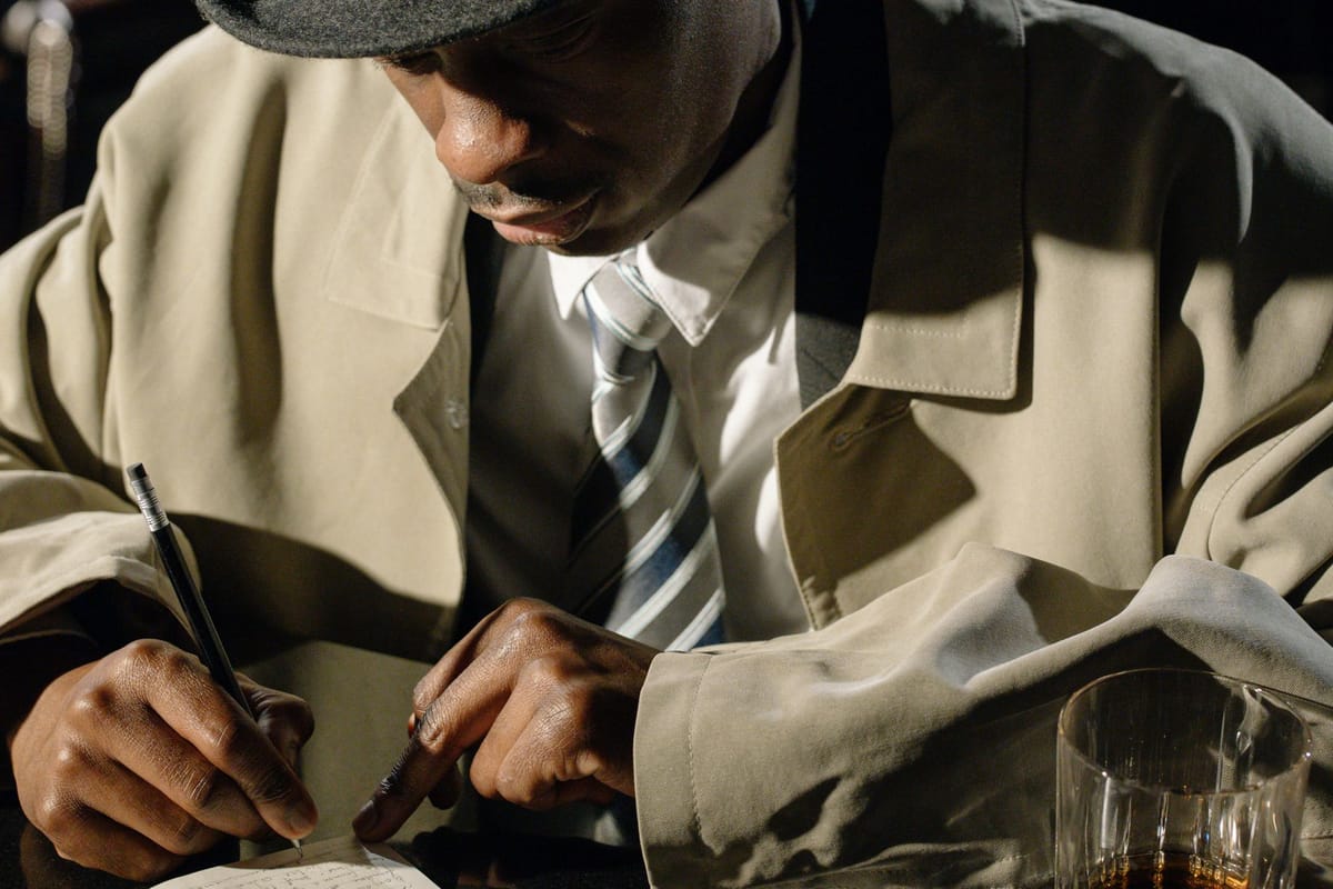 Detective in noir setting examining evidence, symbolizing verification and audit trails